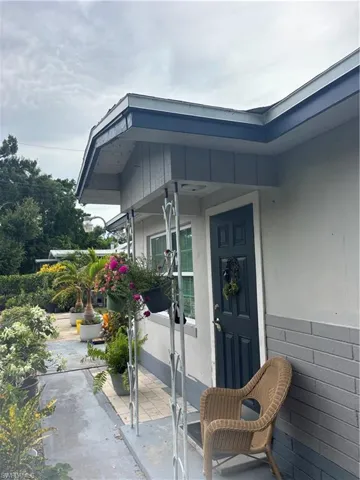 Entrance to property with stucco siding and a patio