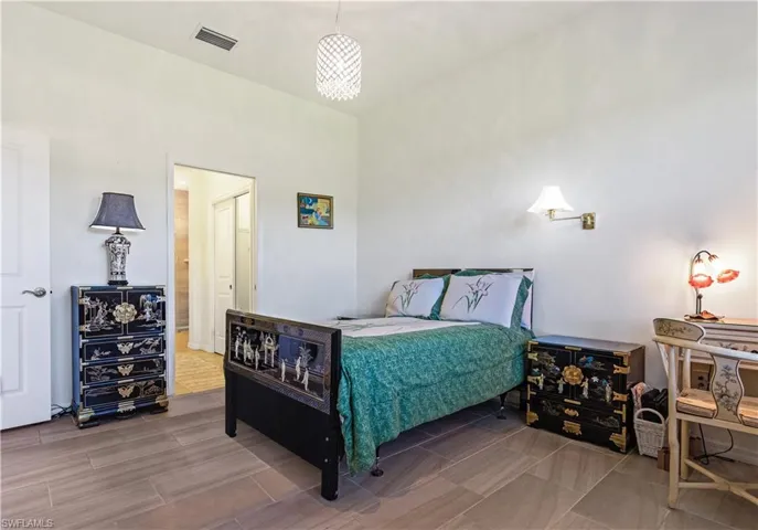 Primary bedroom has double impact resistant windows, ensuite bath, 3 closets.Photo digitally enhanced.