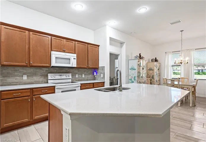 Extra large kitchen island. Whirlpool appliances, recessed lighting, and double sink.Photo digitally enhanced.