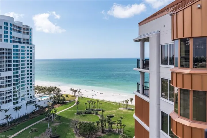 A true landmark in Park Shore, the copper-trimmed beauty is at the surf's edge and alongside a popular beach park.