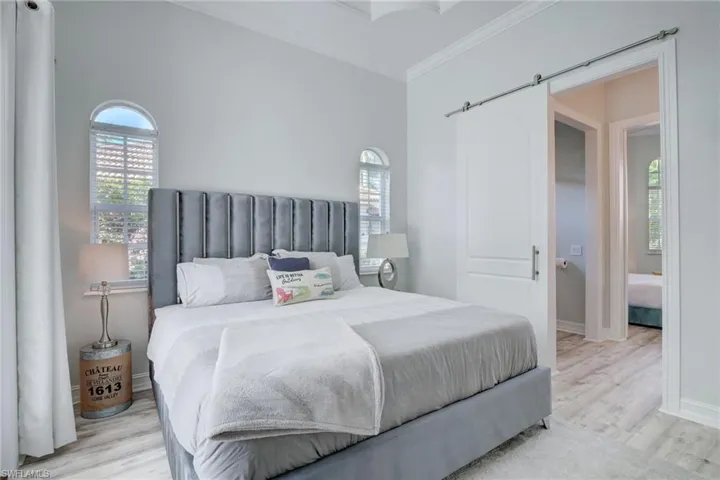 Bedroom featuring crown molding and light hardwood / wood-style flooring