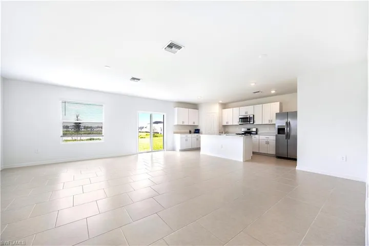 Unfurnished living room featuring recessed lighting and light tile patterned flooring