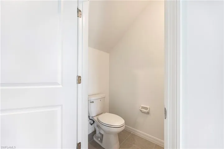 Bathroom featuring lofted ceiling and light tile patterned floors