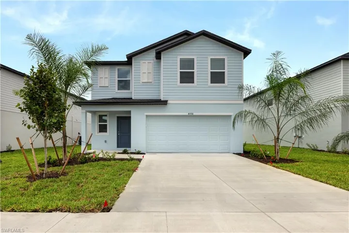 View of front of property with a front lawn, an attached garage, concrete driveway, a porch, and stucco siding