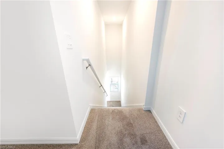 Staircase with carpet flooring and baseboards