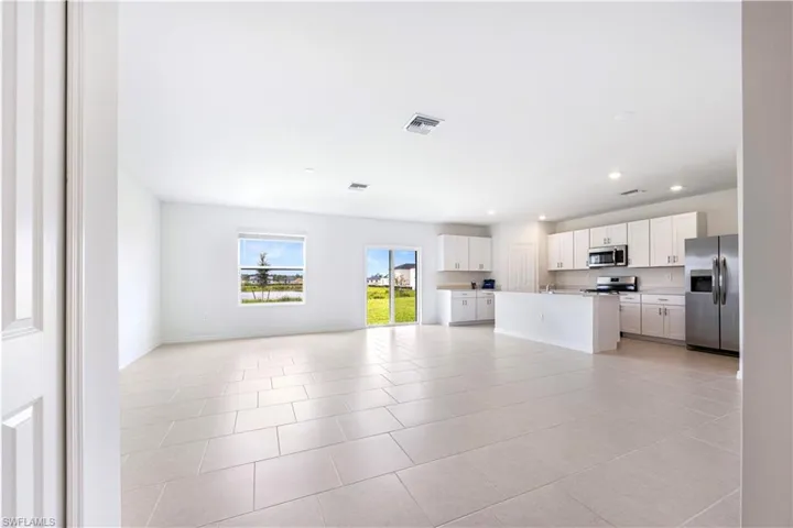 Unfurnished living room featuring recessed lighting and light tile patterned flooring