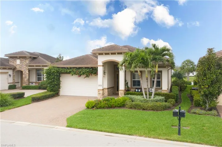 Mediterranean / spanish home with a garage and a front lawn