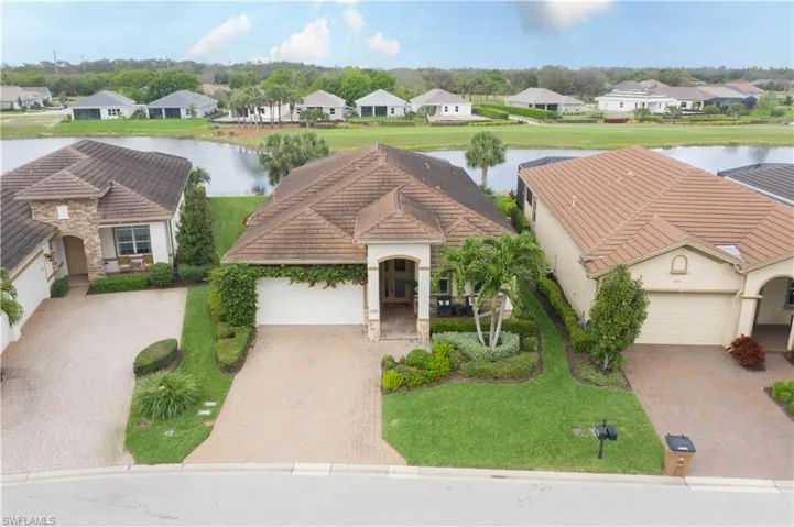View of front facade with a water view and a garage