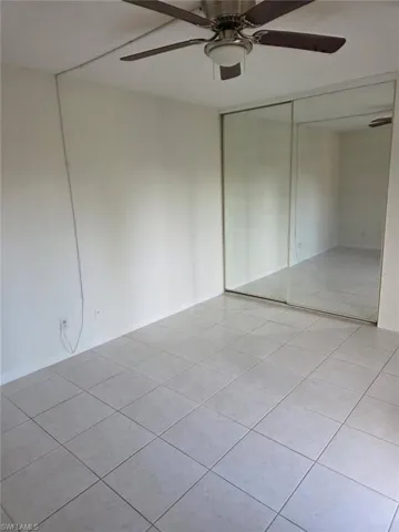 Unfurnished room featuring ceiling fan and light tile patterned floors