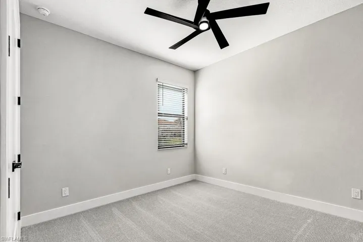 Full bathroom featuring a soaking tub, a stall shower, tile walls, wainscoting, and wood finish floors