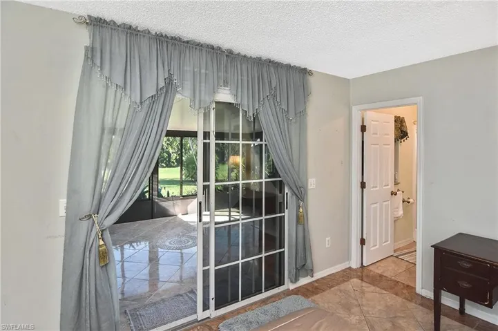 Entryway with a textured ceiling and tile patterned flooring
