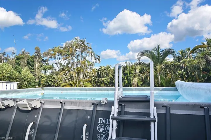 View of swimming pool featuring view of scattered trees