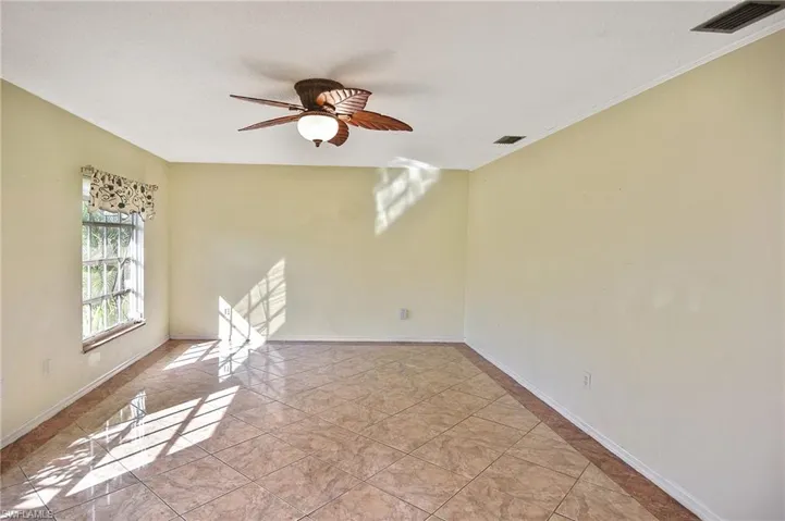 Spare room featuring a ceiling fan and light tile patterned flooring