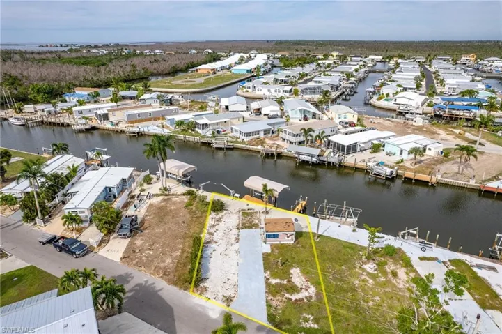 Birds eye view of property with a water view