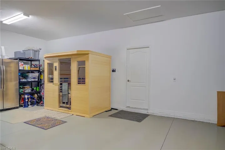 Garage featuring a sauna / steam room and freestanding refrigerator