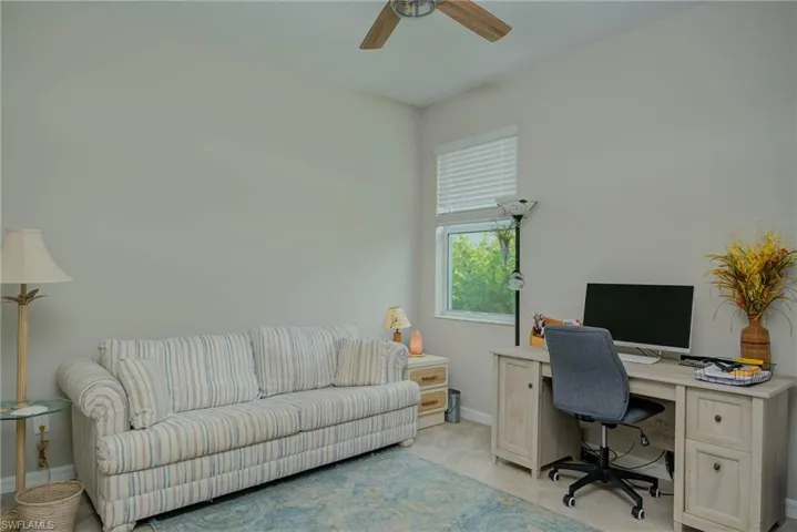 Office area with baseboards and a ceiling fan