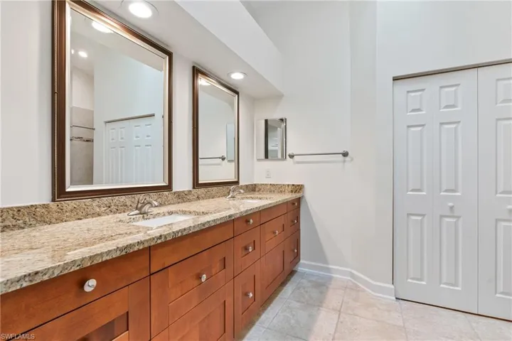 Bathroom with tile floors and double sink vanity