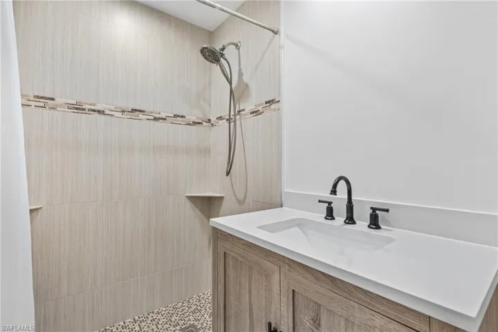 Bathroom with a tile shower and vanity
