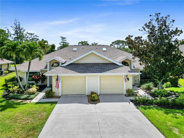 View of front of house with a garage and a front lawn