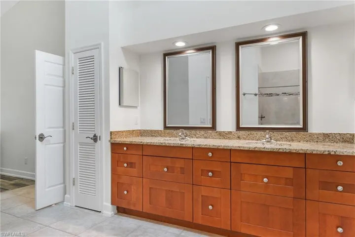 Bathroom with tile flooring, large vanity, and double sink