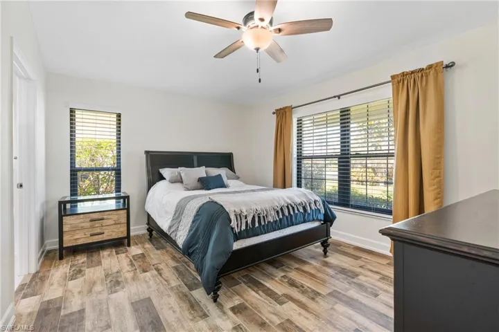 Bedroom with ceiling fan and hardwood / wood-style floors