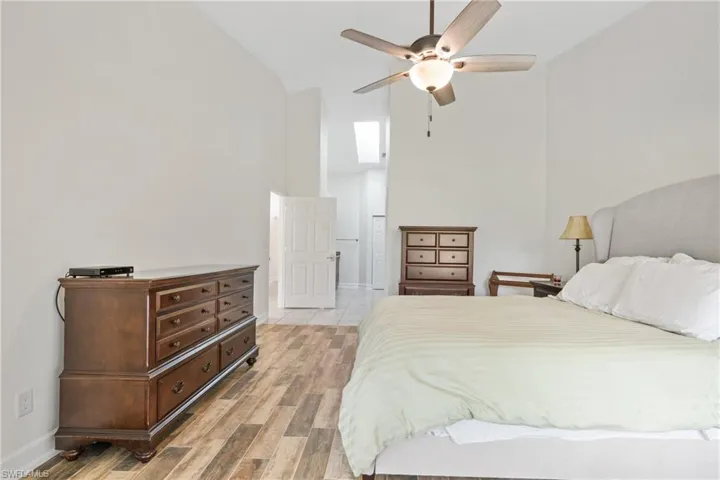 Bedroom featuring high vaulted ceiling, ceiling fan, and light hardwood / wood-style floors