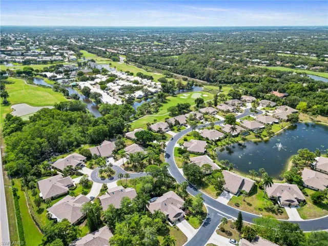 Birds eye view of property with a water view