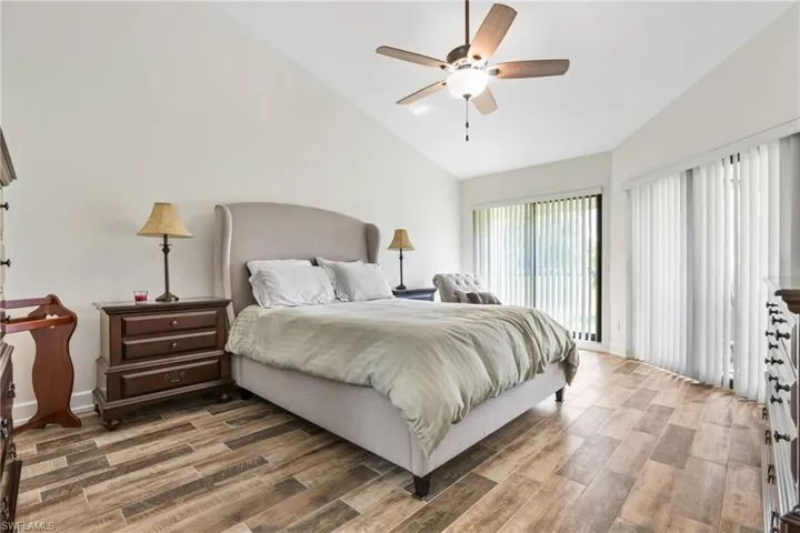 Bedroom featuring high vaulted ceiling, ceiling fan, and hardwood / wood-style floors