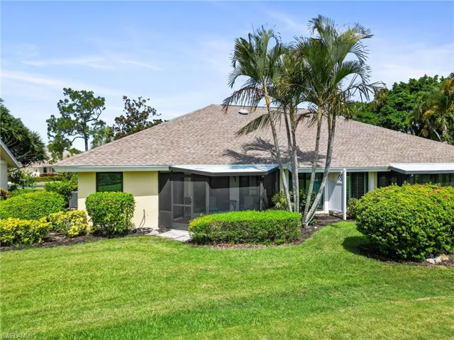 Ranch-style house featuring a sunroom and a front lawn