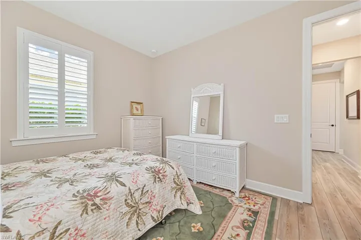 Bedroom with light wood-type flooring and baseboards