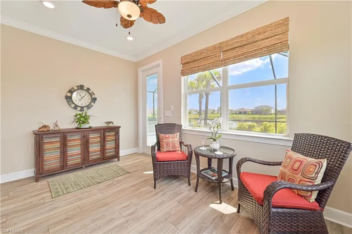 Sitting room featuring crown molding, light wood-type flooring, a ceiling fan, baseboards, and recessed lighting