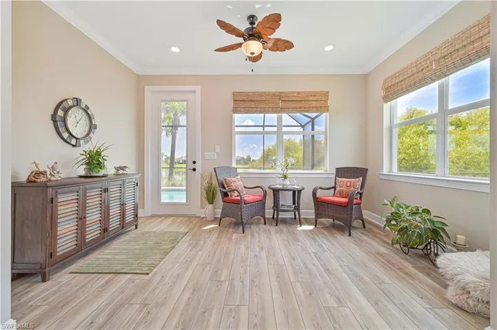 Living area with light wood-style floors, crown molding, ceiling fan, baseboards, and recessed lighting