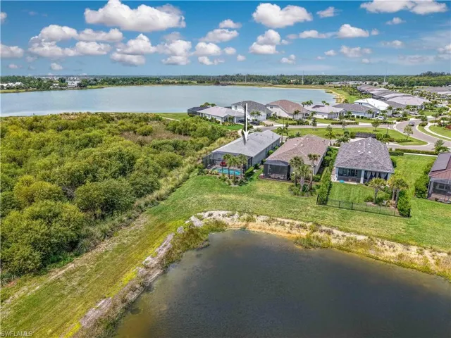 Aerial perspective of suburban area featuring a large body of water