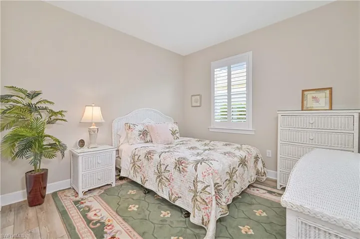 Bedroom featuring wood finished floors and baseboards