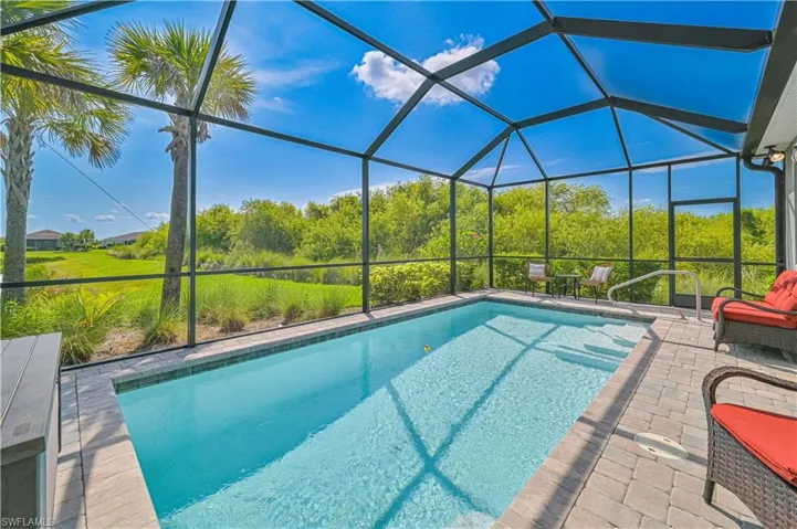 Swimming pool with a patio area and a lanai