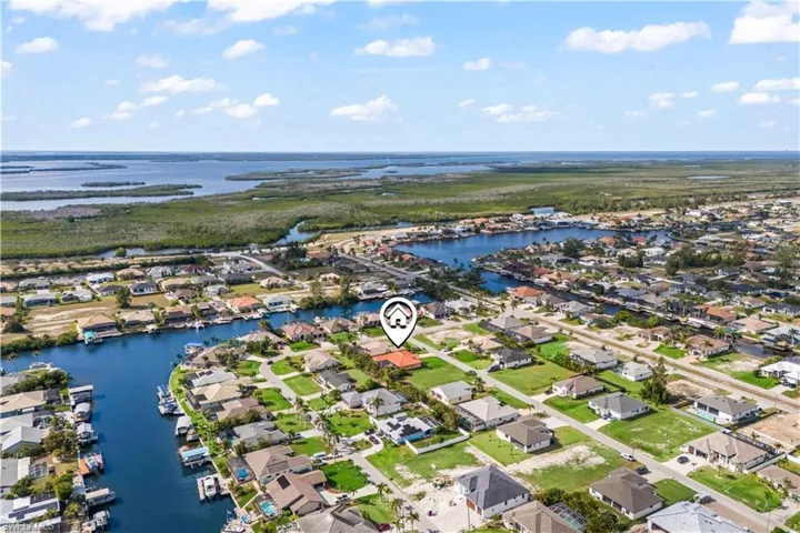 Birds eye view of property with a water view
