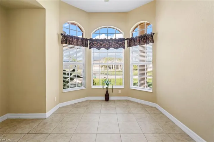Empty room with light tile patterned floors