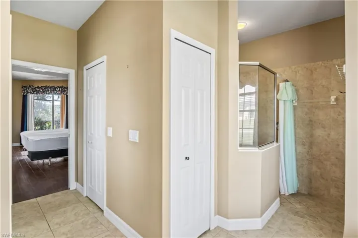 Bathroom with tile patterned floors and a tile shower
