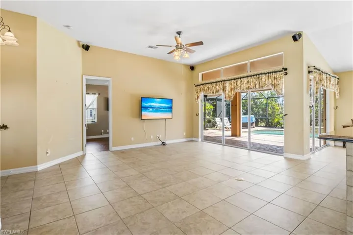 Tiled spare room with ceiling fan