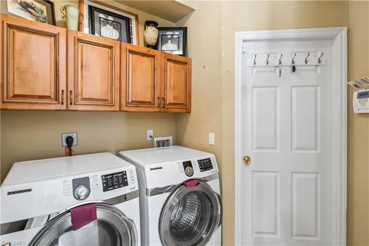 Laundry room with cabinets and washing machine and dryer