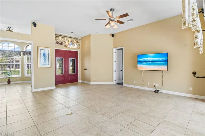 Tiled entryway featuring ceiling fan