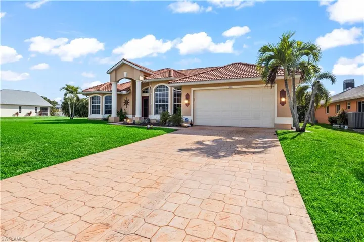 Mediterranean / spanish house featuring a garage and a front yard