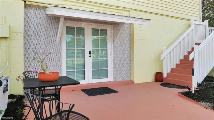 AIRBNB entrance featuring concrete block siding and french doors