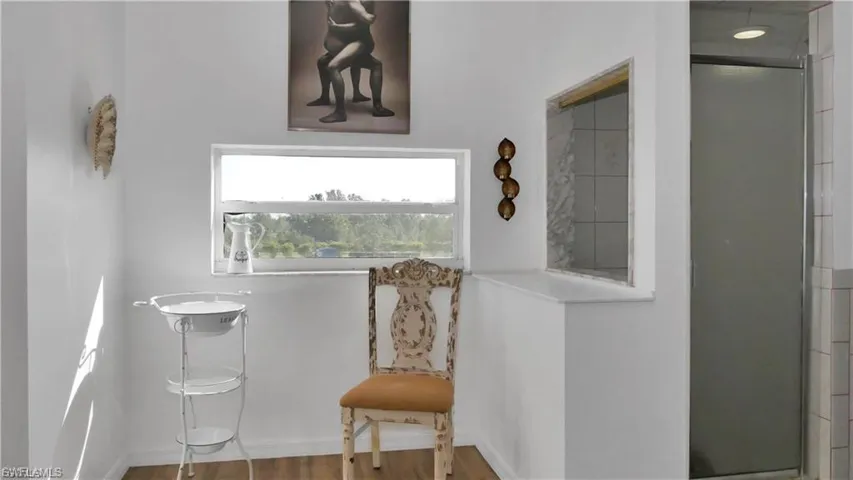 Living area with wood finished floors and baseboards