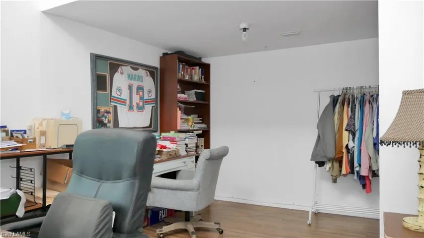 Office with wood finished floors and baseboards