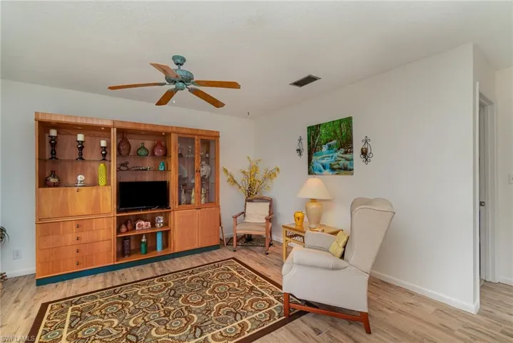 Living room featuring light hardwood / wood-style flooring and ceiling fan