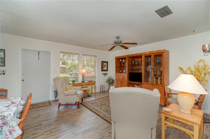 Living room featuring ceiling fanand light hardwood / wood-style flooring