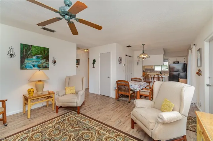 Living room featuring light hardwood / wood-style floors and ceiling fan