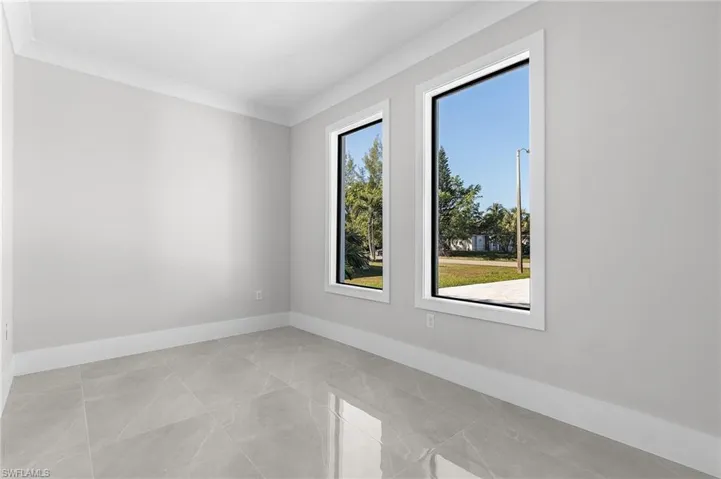 Empty room with plenty of natural light and crown molding