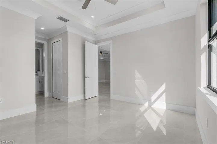 Empty room with ceiling fan and ornamental molding